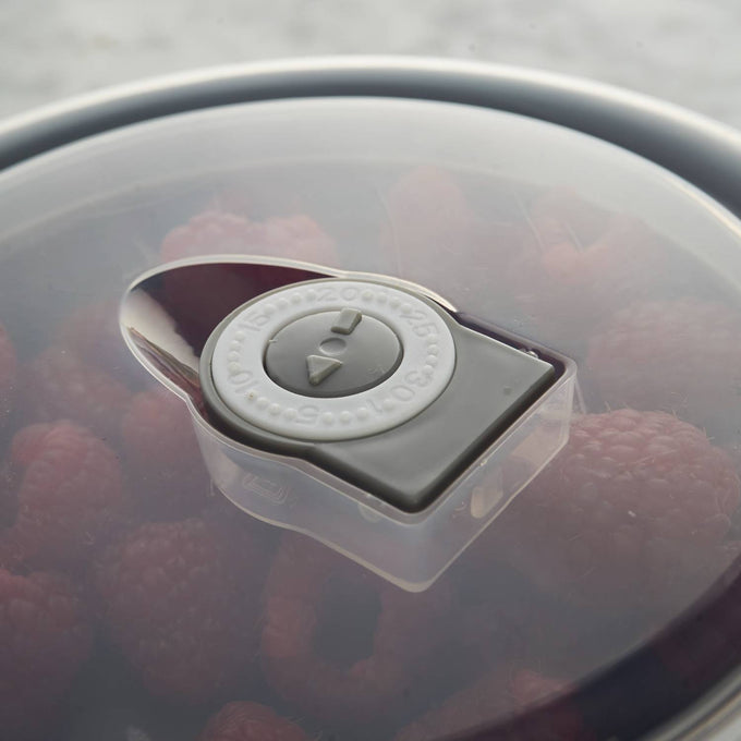 Close-up of a translucent airtight lid with vent dial on a cream-colored all-purpose bowl containing fresh raspberries, ideal for Kitchen & Food, Cookware, Baking Supplies, Storage and Serving, Best Sellers, and Promo Eligible collections.