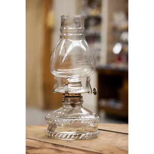 Clear glass oil lamp with a classic shape and metal burner, providing bright, reliable lighting, featured in Farm, Garden & Tool, Lamps & Lighting, Emergency Supplies, and Best Sellers collections.