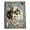Rustic tin sign featuring a detailed squirrel illustration and the phrase "Welcome to The Nut House" in decorative lettering, handcrafted and made in USA for home decor.