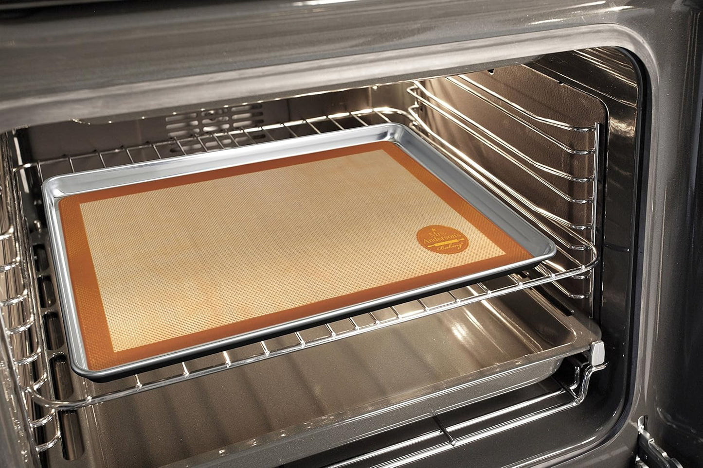 Large non-stick silicone baking mat with brown trim placed on a metal baking sheet inside an oven, designed for durability in Kitchen & Food, Cookware, Baking Supplies, and Best Sellers collections.
