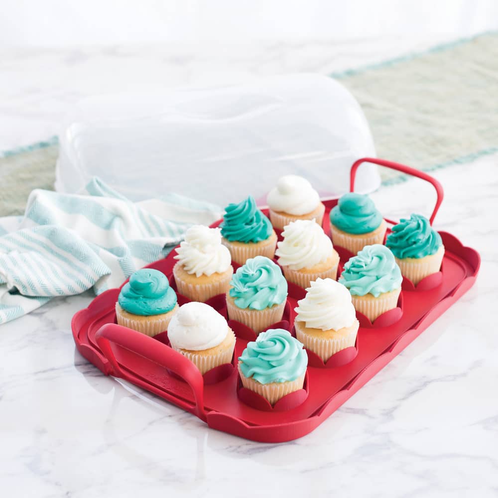 Reversible cupcake carrier with a scalloped red tray holding twelve cupcakes topped with white and teal frosting, featuring snap-lock handles and a clear domed lid, made in USA for Kitchen & Food and Baking Supplies collections.