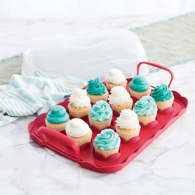 Reversible cupcake carrier with a scalloped red tray holding twelve cupcakes topped with white and teal frosting, featuring snap-lock handles and a clear domed lid, made in USA for Kitchen & Food and Baking Supplies collections.