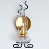Wall-mounted oil lamp with clear glass chimney, solid brass reflector, and decorative black metal bracket, highlighting handcrafted USA made quality in Lamps & Lighting and Oil Lamps collections.