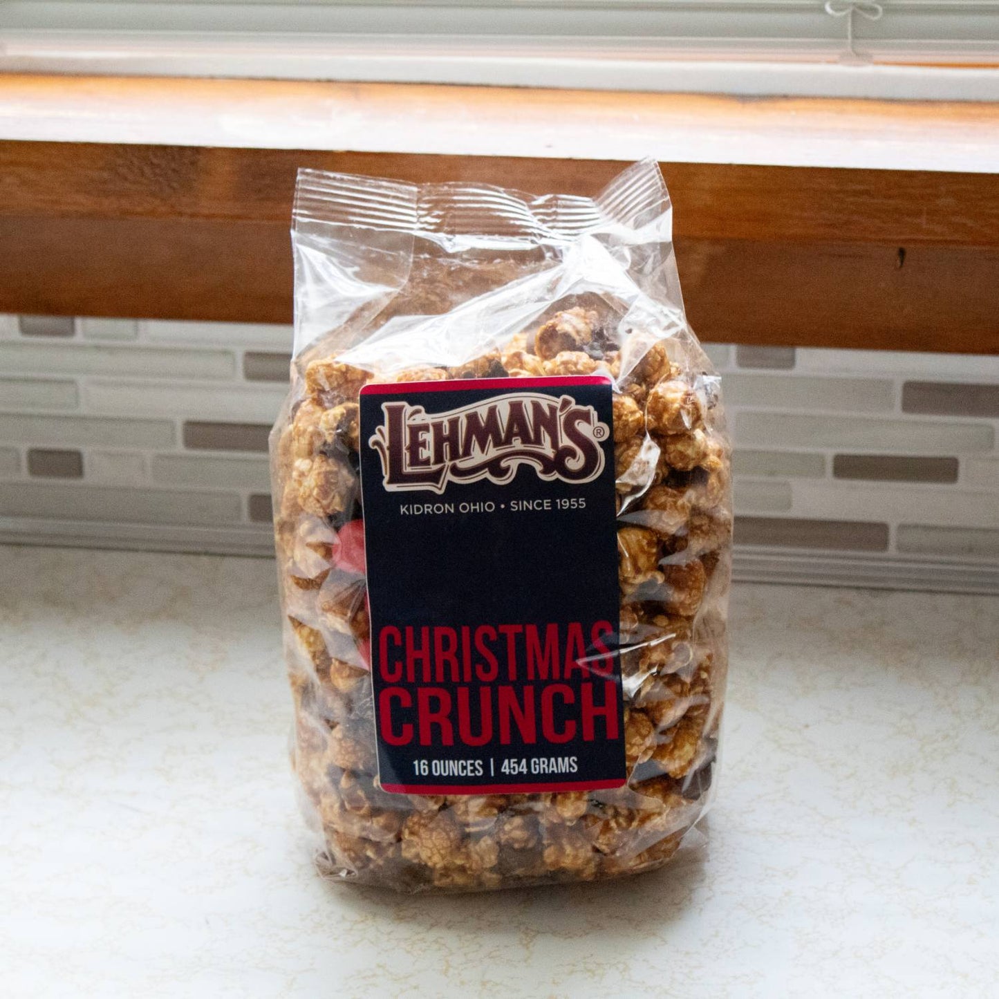 Clear bag of handcrafted caramel popcorn mixed with milk chocolate and holiday-inspired treats, featured in Kitchen & Food, Snacks and Sweets, Popcorn, Best Sellers, and Promo Eligible collections.