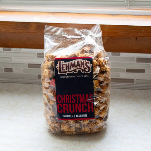 Clear bag of handcrafted caramel popcorn mixed with milk chocolate and holiday-inspired treats, featured in Kitchen & Food, Snacks and Sweets, Popcorn, Best Sellers, and Promo Eligible collections.