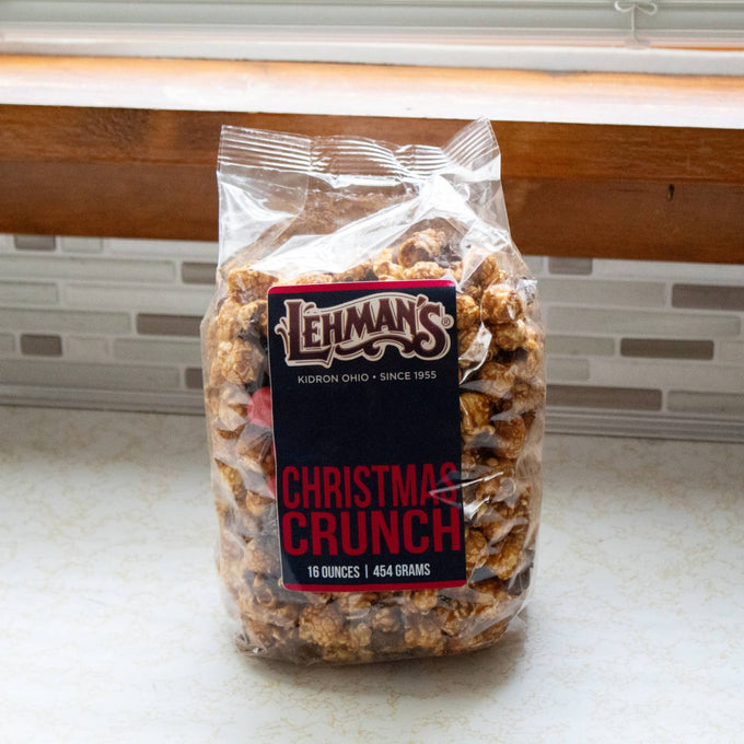 Clear bag of handcrafted caramel popcorn mixed with milk chocolate and holiday-inspired treats, featured in Kitchen & Food, Snacks and Sweets, Popcorn, Best Sellers, and Promo Eligible collections.
