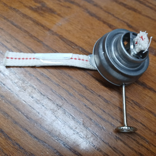 Metal oil lantern burner with attached cotton wick, designed as a replacement part for camping, barn, and emergency lamps, featured in lamp burners and outdoor lighting collections.
