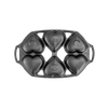 Cast iron mini cake pan with six heart-shaped molds, featuring sturdy handles and a naturally seasoned surface, ideal for baking in Kitchen & Food and Cast Iron collections.