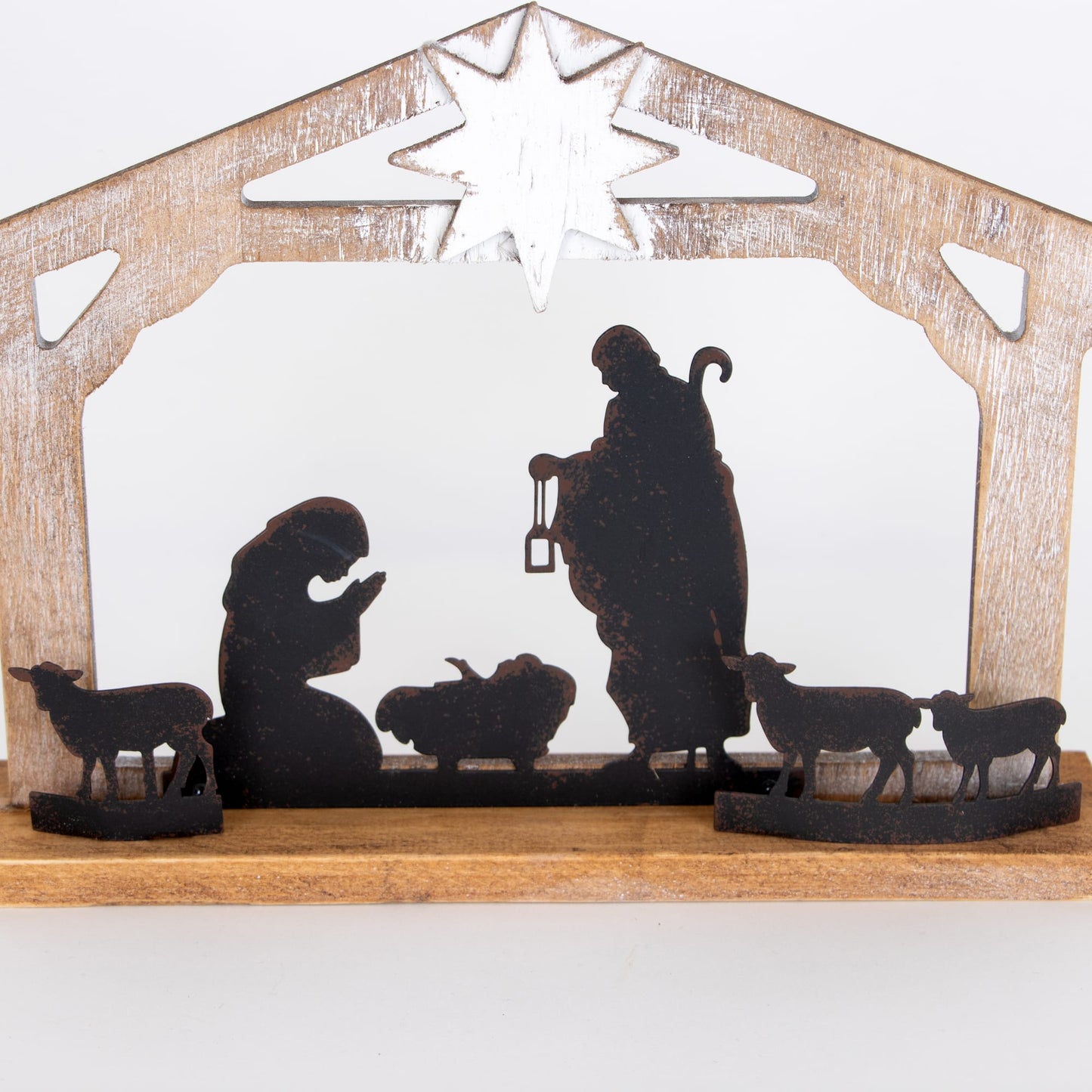 Handcrafted wooden nativity display with weathered finish featuring metal silhouettes of the Holy Family and animals beneath a star, ideal for Home & Decor, Holiday Decor, and Best Sellers collections.