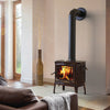 Cozy living room featuring a handcrafted Hearthstone Crafts wood stove with visible flame, black pipe vent, set against a neutral wall near a tall window and woven decor, part of best-selling heatstoves collection.