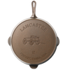 Bottom view of a handcrafted American cast iron skillet featuring embossed design of a horse-drawn wagon and "Lancaster Pennsylvania USA" text, ideal for Kitchen & Food, Cookware, Cast Iron, and USA Made collections.