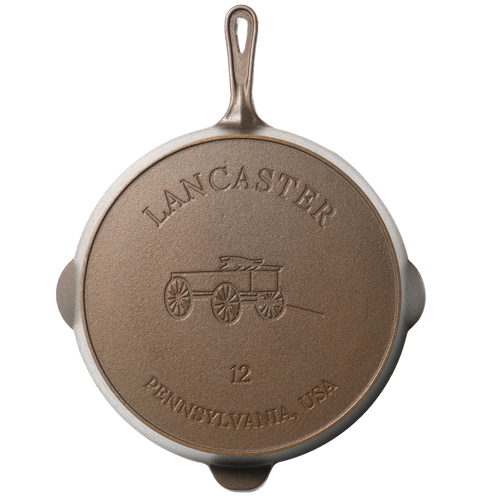 Bottom view of a handcrafted American cast iron skillet featuring embossed design of a horse-drawn wagon and "Lancaster Pennsylvania USA" text, ideal for Kitchen & Food, Cookware, Cast Iron, and USA Made collections.
