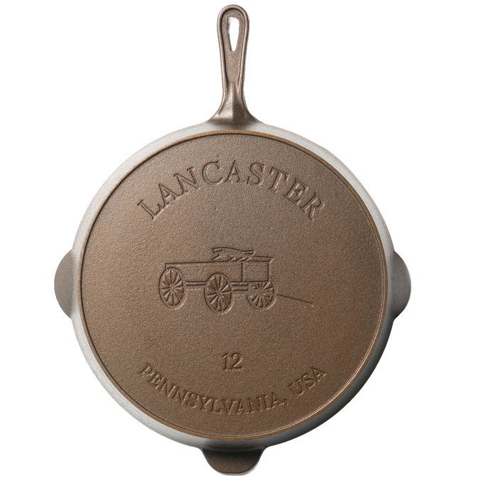 Bottom view of a handcrafted American cast iron skillet featuring embossed design of a horse-drawn wagon and "Lancaster Pennsylvania USA" text, ideal for Kitchen & Food, Cookware, Cast Iron, and USA Made collections.