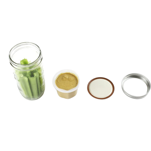 Clear wide-mouth jar filled with celery stalks alongside a plastic divider cup with beige dip, plus two separate metal jar lids, showcasing a handcrafted lunch container accessory made in USA for Kitchen & Food and Storage collections.