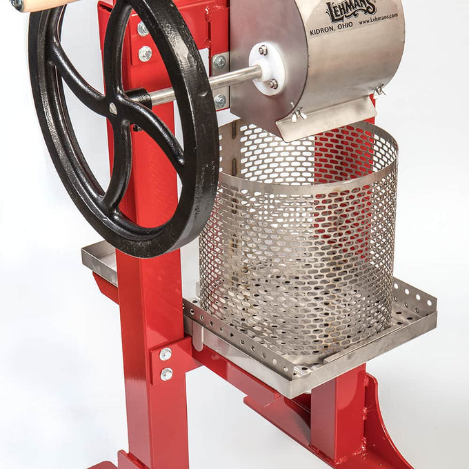 Handcrafted Lehman’s fruit press featuring a red frame, stainless steel mesh basket, and black cast iron crank wheel, ideal for orchard use and featured in Farm, Garden & Tool collections.