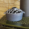 Heavy-duty flat black cast iron stovetop steamer with a lattice vented lid, designed to add natural moisture to indoor air, featured in Stoves, Hearth Accessories, and Best Sellers collections.