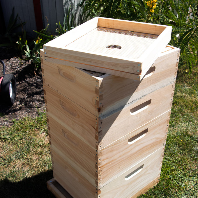 Handcrafted wooden 10-frame candy board feeder with wire mesh cover, Amish made in the USA, designed for beekeeping supplies within farm, garden, and tool collections.