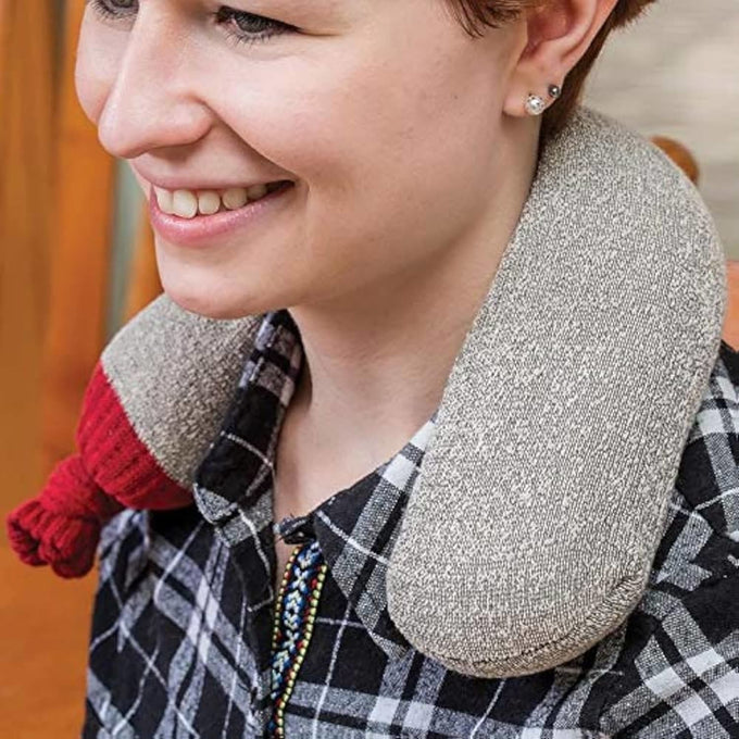 Smiling person wearing a handcrafted black walnut hot pack around the neck, designed for soothing aches and pains, made in USA and featured in Health & Wellness collections.