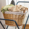 Handwoven split willow laundry basket with cloth lining and rope handles holding towels, ideal for small loads and delicates in laundry supplies and home decor collections.