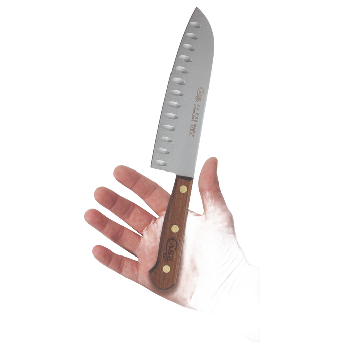 Handheld 7-inch Santoku knife with a wooden handle and distinctive blade dimples designed to prevent food sticking, crafted for kitchen and food prep in USA Made and Best Sellers collections.
