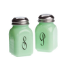Set of two vintage-style glass salt and pepper shakers in pale green with black monograms and stainless steel tops, handcrafted in the USA for Kitchen & Food collections.
