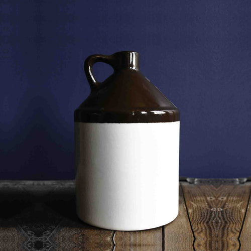 Handmade stoneware jug with a handle in brown and white glaze, crafted in the USA, ideal for Kitchen & Food, Storage and Serving, Best Sellers, and Promo Eligible collections.