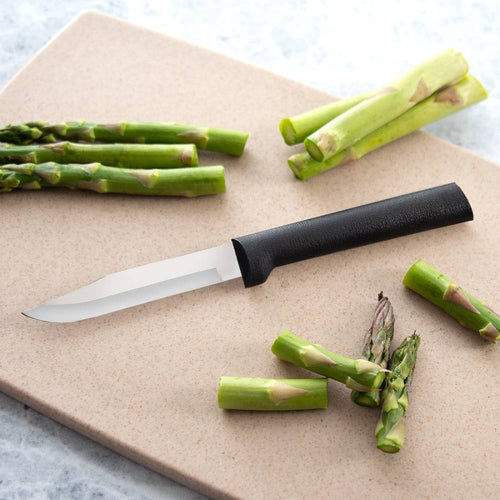 Handcrafted paring knife with black handle on beige cutting board surrounded by trimmed green asparagus, featured in Kitchen & Food, Knives & Axes, and USA Made collections.