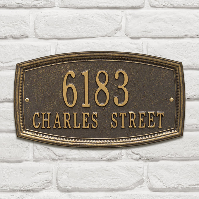 Raised bronze wall plaque displaying house number and street name with a decorative border, handcrafted and made in USA, featured in Home & Decor and Mailboxes and Address Signs collections.