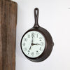 Handcrafted cast iron skillet wall clock with light green undertone face and black numerals, made in USA, ideal for Home & Decor, Cast Iron, and Best Sellers collections.