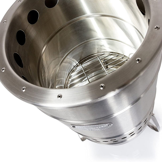 Top-down view of a double-walled stainless steel fire barrel with ventilation holes and a metal grate inside, designed for outdoor use in farm, garden, camping, and best sellers collections.