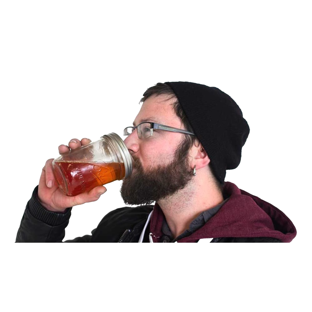 Man wearing glasses and a black beanie sipping a drink from a wide-mouth mason jar with a clear reusable drinking lid, part of Kitchen & Food, USA Made, and Best Sellers collections.