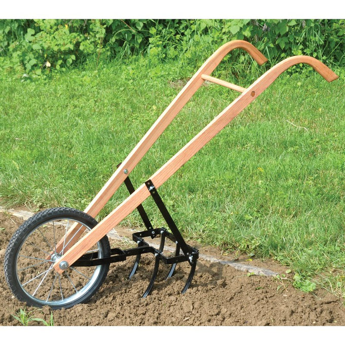 Handcrafted garden cultivator with wooden handles and sharp tines for loosening soil and weeding, featuring a single large wheel for easy maneuvering in farm and garden use.