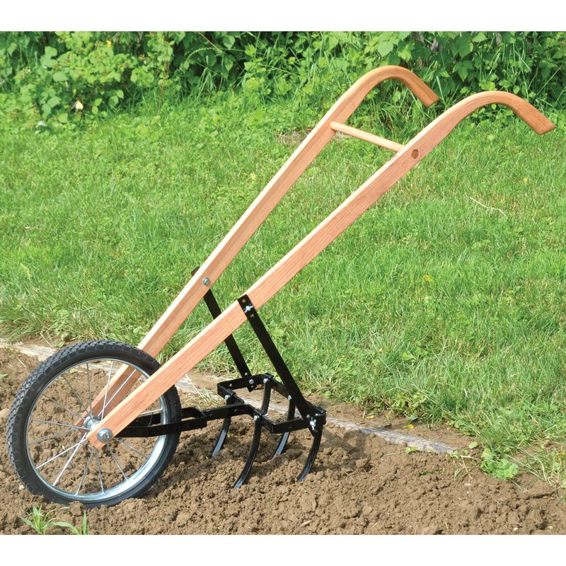Handcrafted garden cultivator with wooden handles and sharp tines for loosening soil and weeding, featuring a single large wheel for easy maneuvering in farm and garden use.