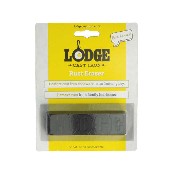 Rectangular rust eraser bar embossed with "LODGE" in clear packaging with yellow and white backing, designed for restoring cast iron cookware, featured in Kitchen & Food and Household Cleaning collections.