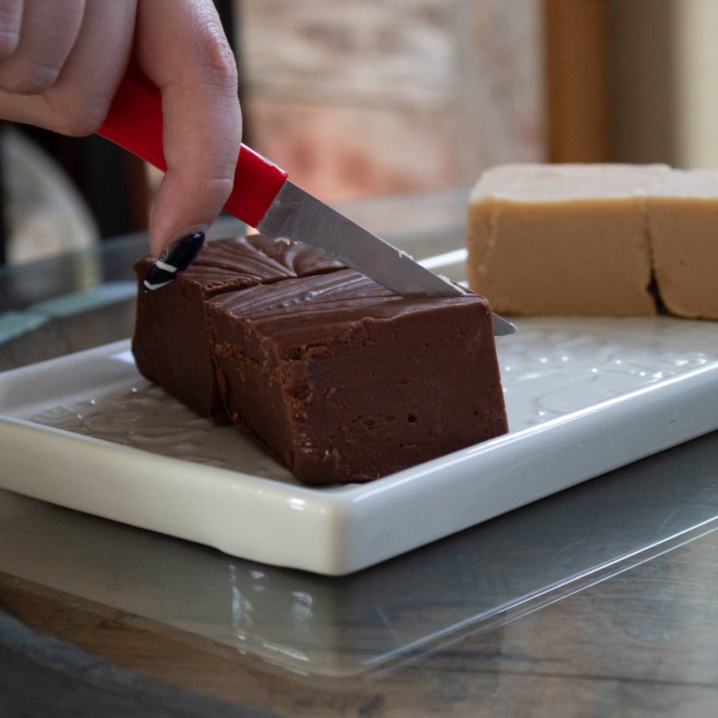 Handcrafted rich chocolate and creamy beige fudge pieces being sliced on a white tray, perfect for Kitchen & Food, Snacks and Sweets, Best Sellers, and Promo Eligible collections.
