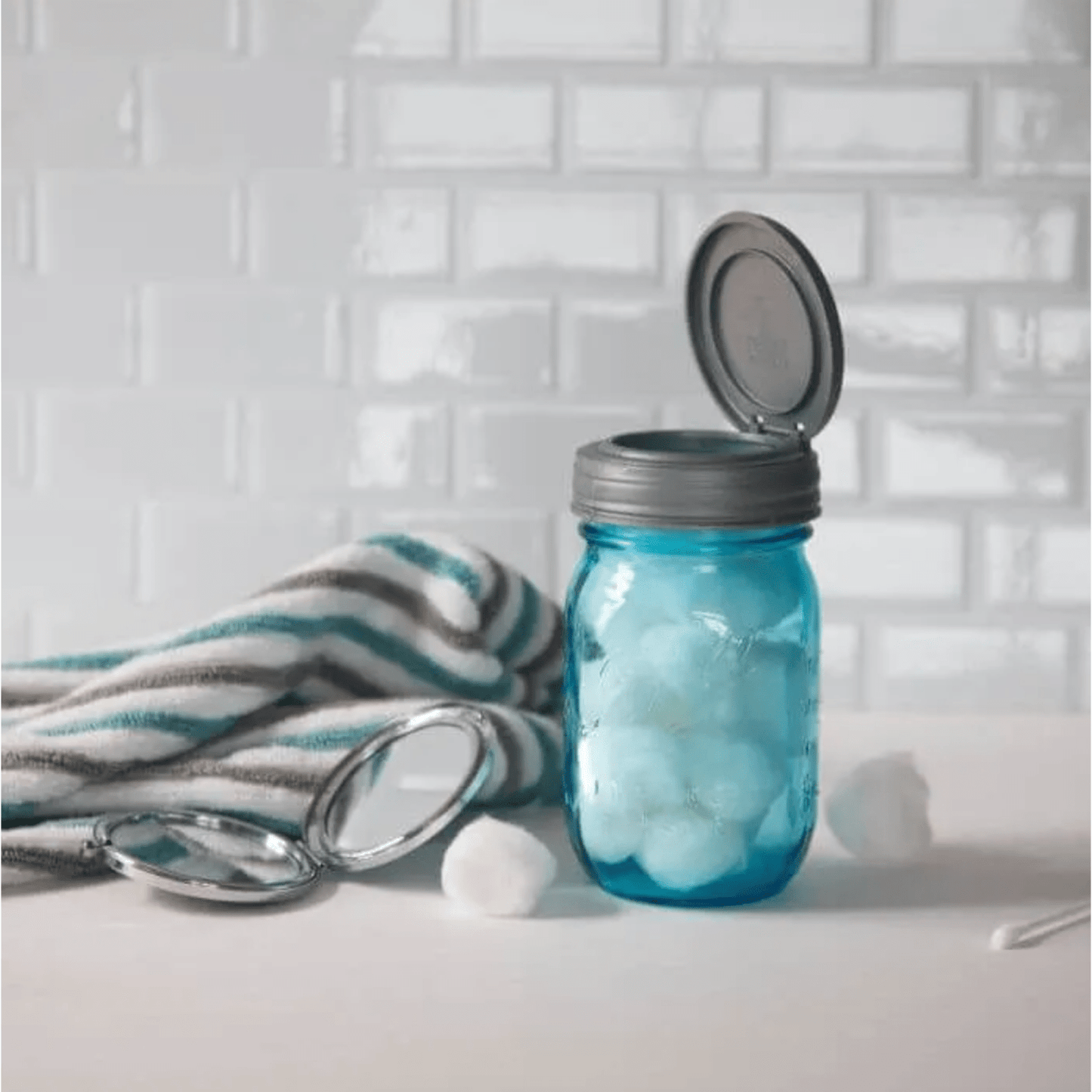 Handcrafted blue glass jar with a gray flip top lid opened, filled with cotton balls, showcased for Home & Decor, Kitchen Gadgets, Household Helpers, and Storage and Serving collections.