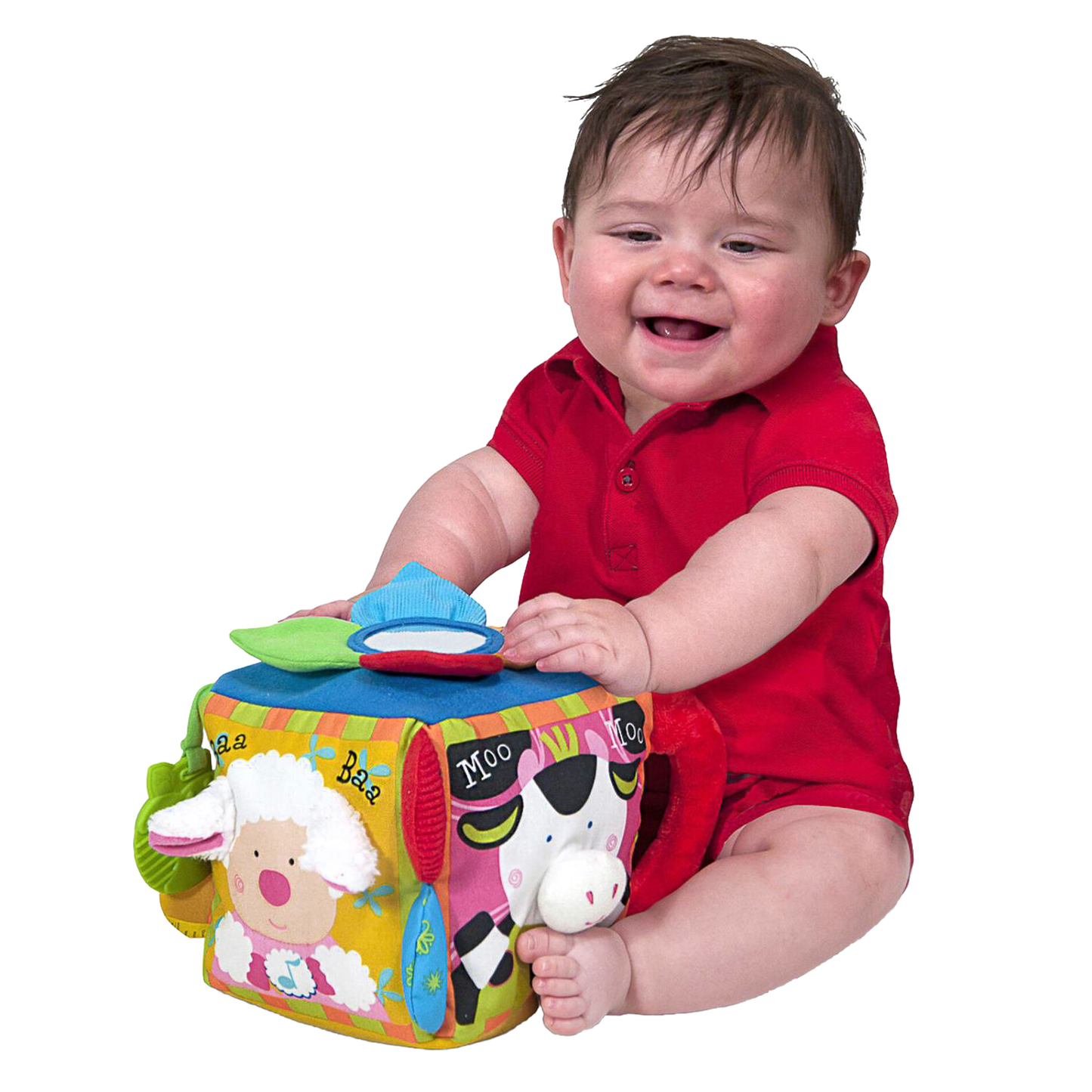 Baby in red outfit playing with colorful fabric musical farmyard cube featuring animal faces, textured details, and interactive sound elements, ideal for indoor play and learning.