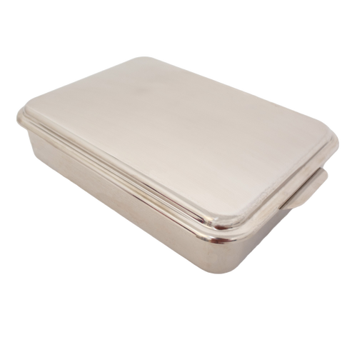 Rectangular stainless steel cake pan with fitted lid, designed for baking and transporting cakes, casseroles, and desserts, featured in kitchen and holiday hosting collections.