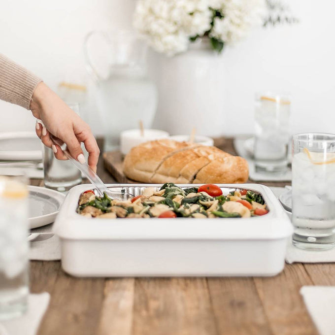 White Fancy Panz foil pan cover with clear removable window, shown in use on a wood dining table with food inside, ideal for Kitchen & Food, Storage and Serving, USA Made, and Best Sellers collections.