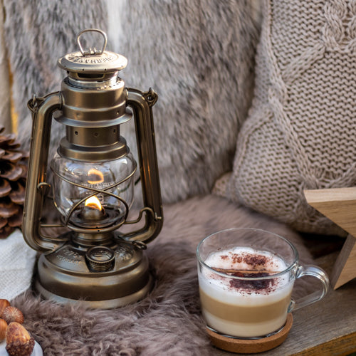 Handcrafted galvanized oil lantern with heat-resistant SUPRAX globe, providing warm, reliable light for camping, emergency supplies, and cozy outdoor or barn settings.