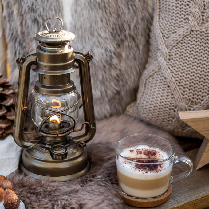 Handcrafted galvanized oil lantern with heat-resistant SUPRAX globe, providing warm, reliable light for camping, emergency supplies, and cozy outdoor or barn settings.