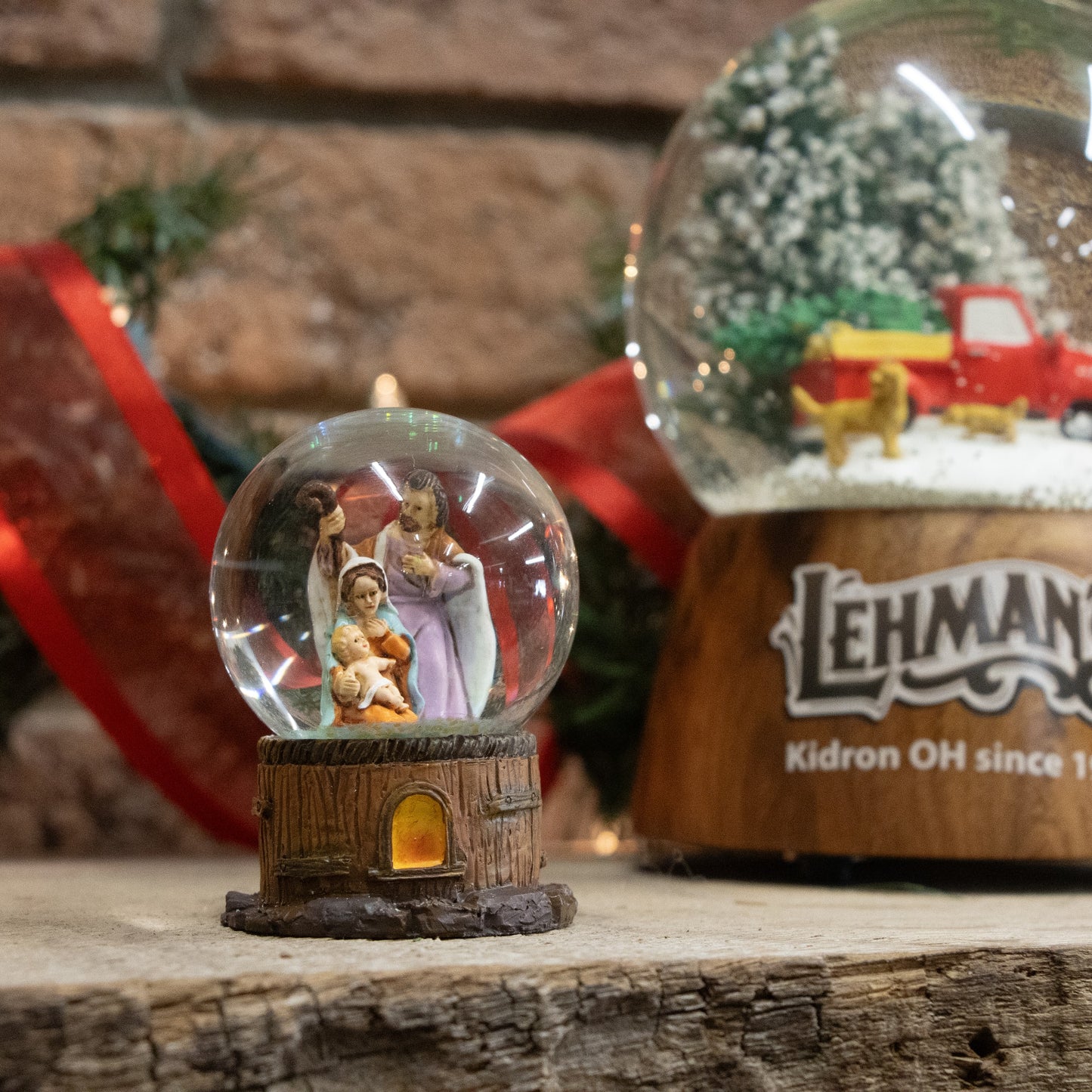 Handcrafted miniature glitter snow globe featuring detailed Holy Family figurines inside a glass dome with a rustic wood-textured base, perfect for Home & Decor and Holiday Decor collections.