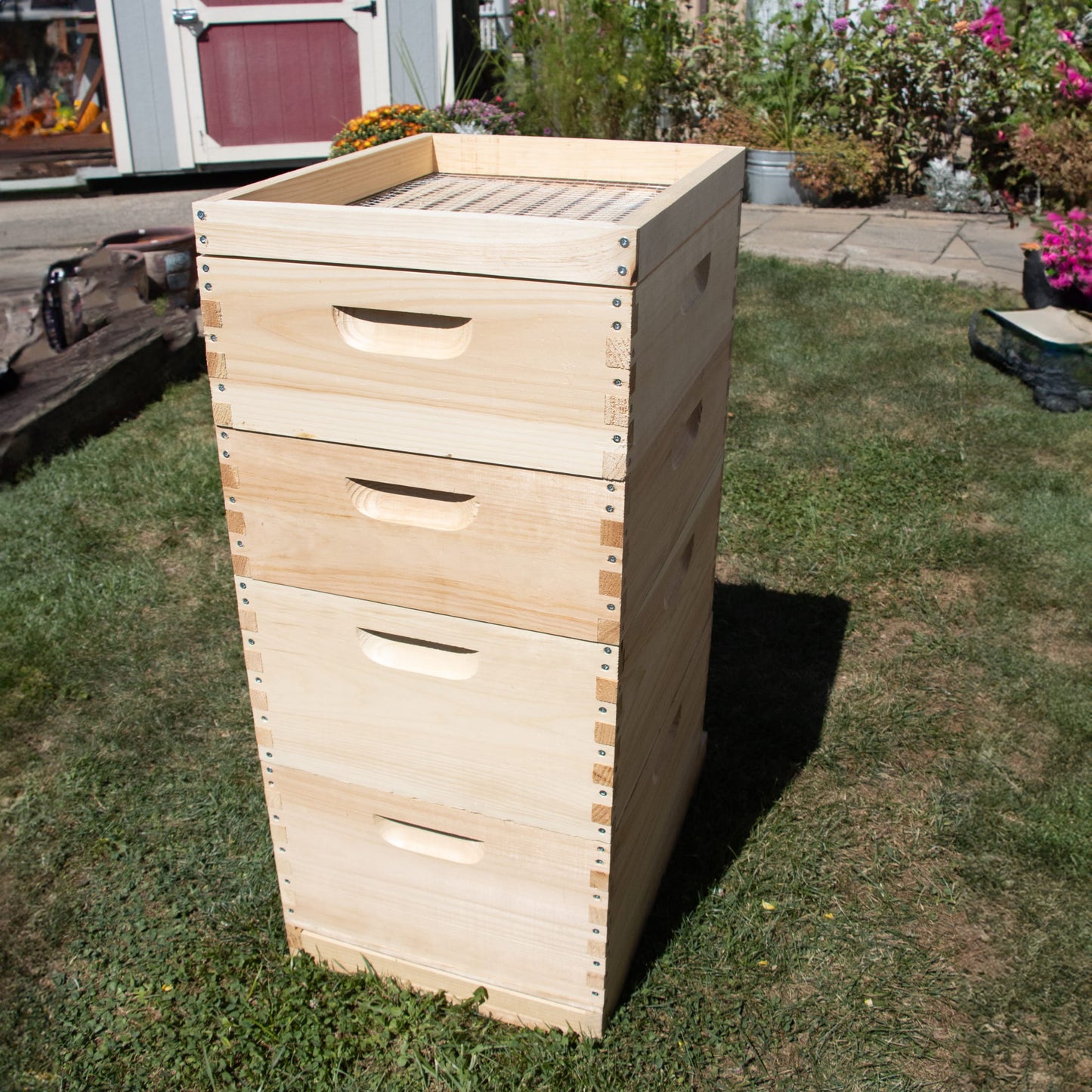 Handcrafted 10-frame wooden feeder box made in the USA, Amish made, designed for beekeeping supplies and farm, garden, and tool collections, shown outdoors on grass.