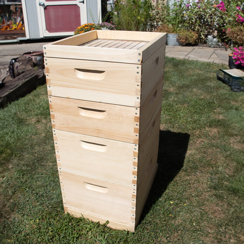 Handcrafted 10-frame wooden feeder box made in the USA, Amish made, designed for beekeeping supplies and farm, garden, and tool collections, shown outdoors on grass.
