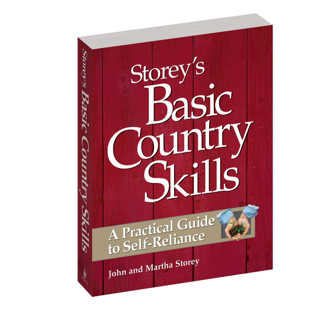Book titled "Basic Country Skills" by John and Martha Storey, with a rustic red wooden background cover, offering practical self-reliance guidance for heritage and lifestyle book collections.