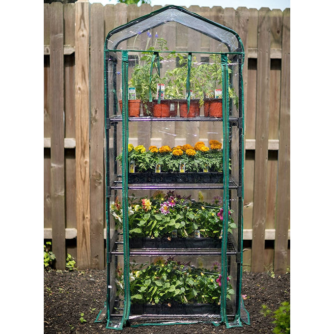 Tall compact greenhouse with four green wire grid shelves holding various potted plants and flowers, featuring a clear plastic zippered roll-up door for easy access, ideal for Farm, Garden & Tool, Garden Accessories, Seeds and Planting, Best Sellers, and Promo Eligible collections.