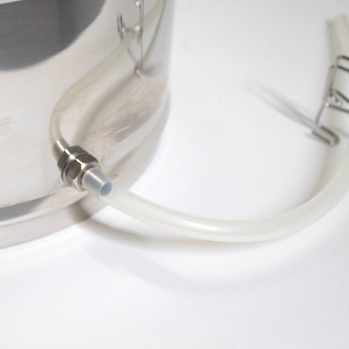 Close-up of a stainless steel steam juicer's leak-proof spout with attached flexible clear tubing on a white background, suitable for Kitchen & Food, Juicers and Steamers, Best Sellers, and Promo Eligible collections.