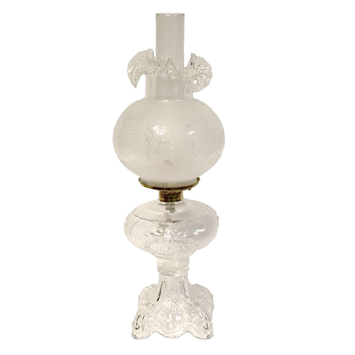 Handcrafted clear glass oil lamp with intricately sculptured base and frosted chimney, featuring a heavy brass-plated burner, perfect for Lamps & Lighting, Oil Lamps, Table Lamps, Best Sellers, and Promo Eligible collections.