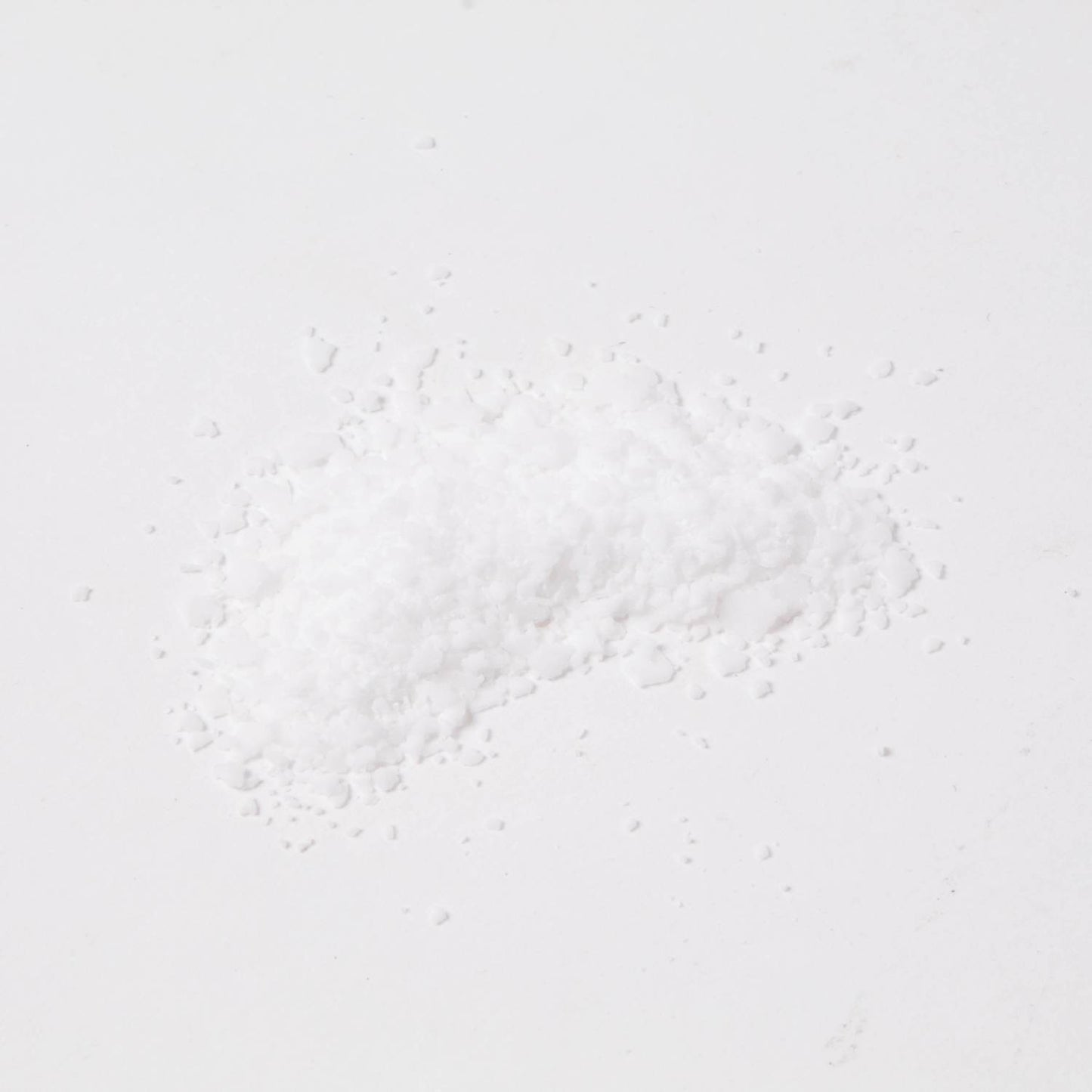 Small pile of fine white stearic acid flakes used in candlemaking to strengthen and harden wax, featured in Health & Wellness, Candlemaking Supplies, and Best Sellers collections.