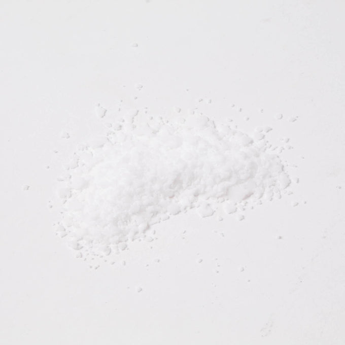 Small pile of fine white stearic acid flakes used in candlemaking to strengthen and harden wax, featured in Health & Wellness, Candlemaking Supplies, and Best Sellers collections.